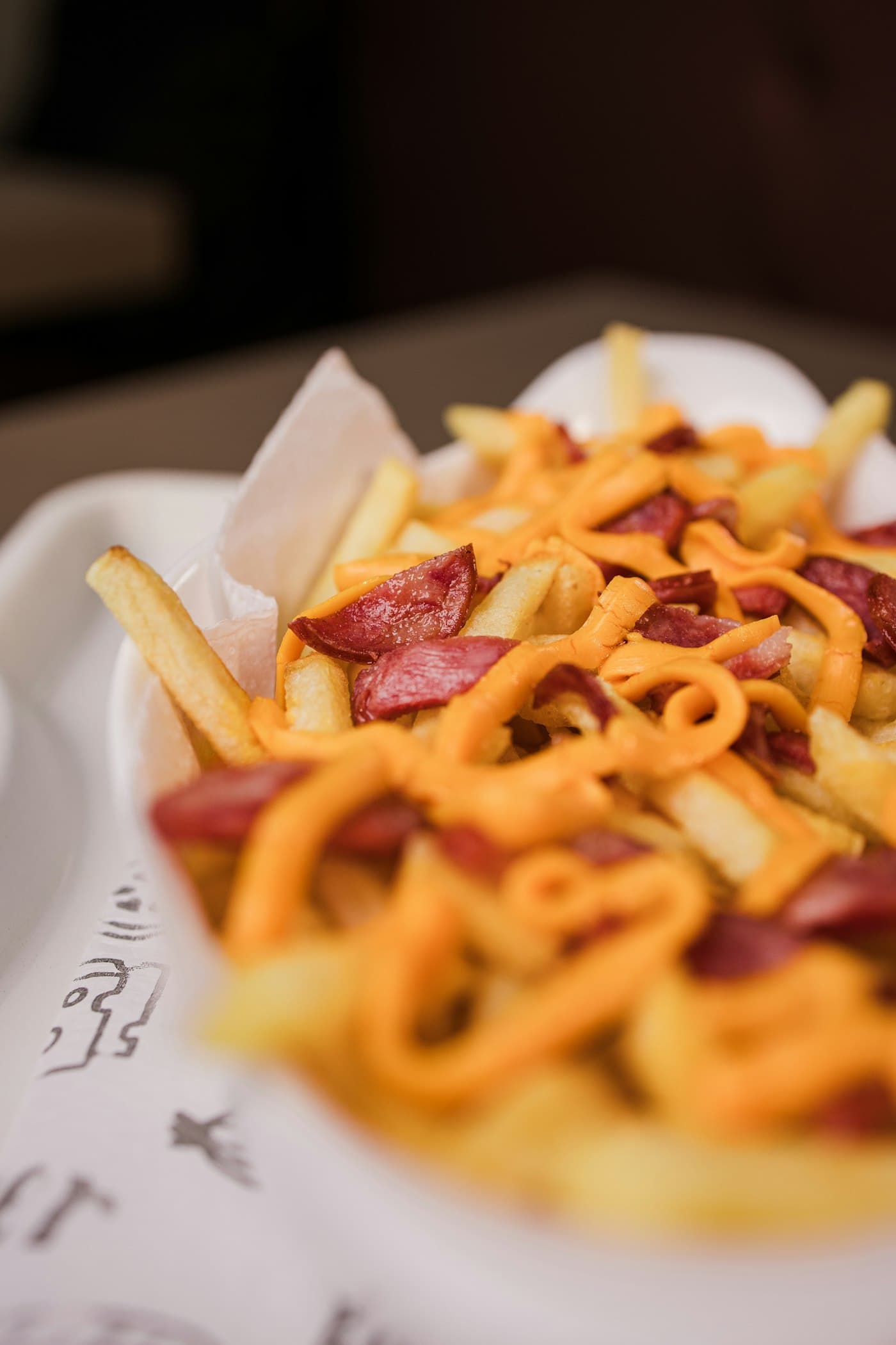 Loaded fries in a dark, moody close-up